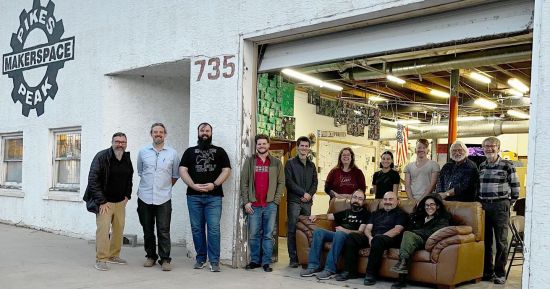 A group of 13 Pikes Peak Makerspace members standing in the front entrance of our 'space